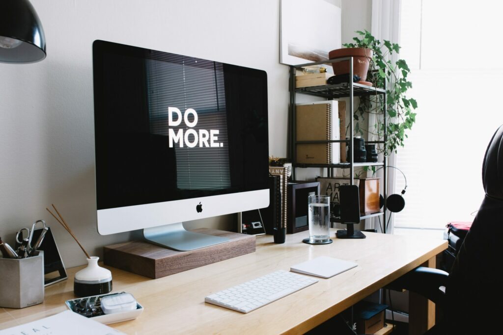 foto ilustrativa do post sobre plantas no home office. Na foto, um escritório  em casa com uma estante com um vaso de planta.